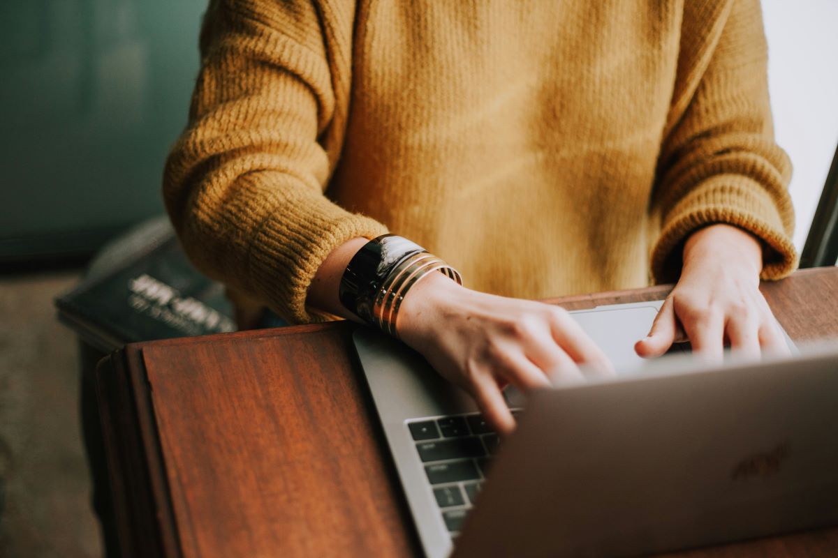 Person with laptop on desk