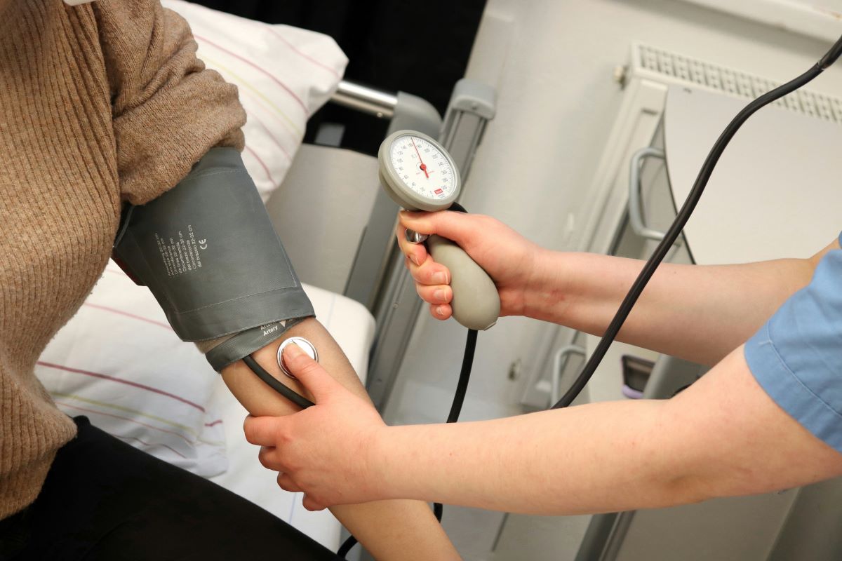 Medical assistant taking a patient's blood pressure